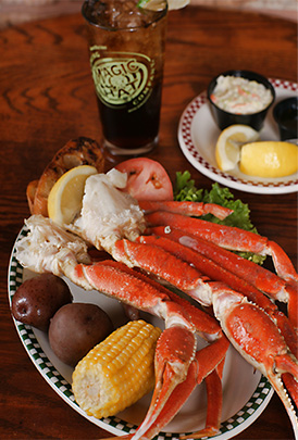 A plate of crab legs and corn on the cob.